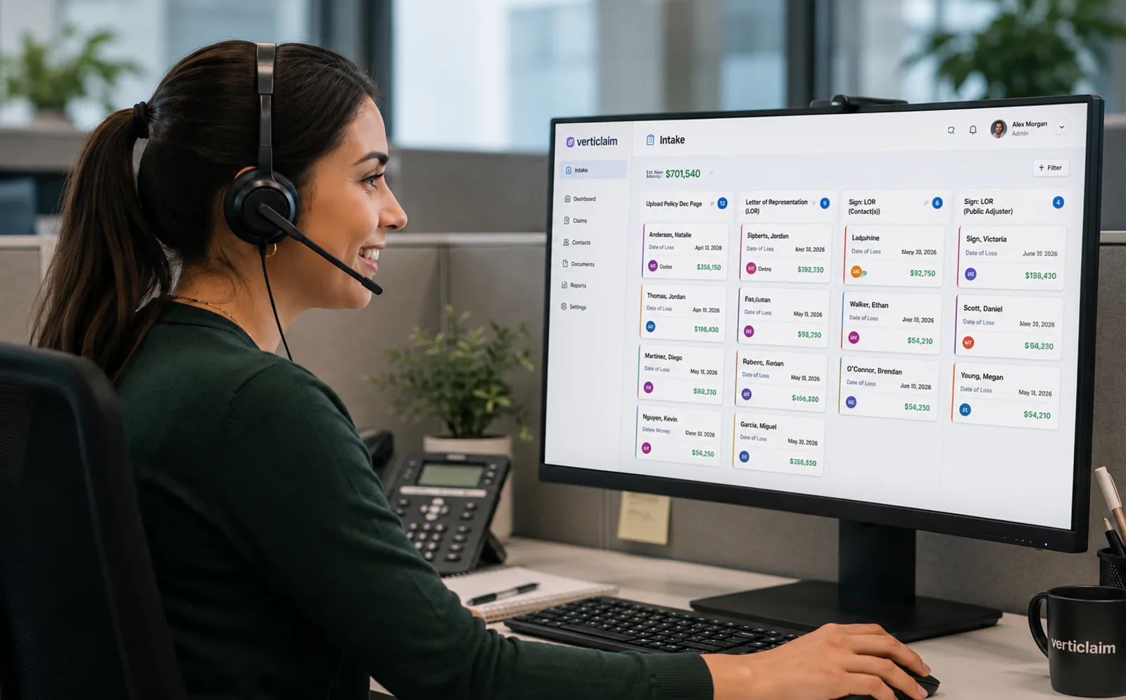 A claims professional wearing a headset at her workstation